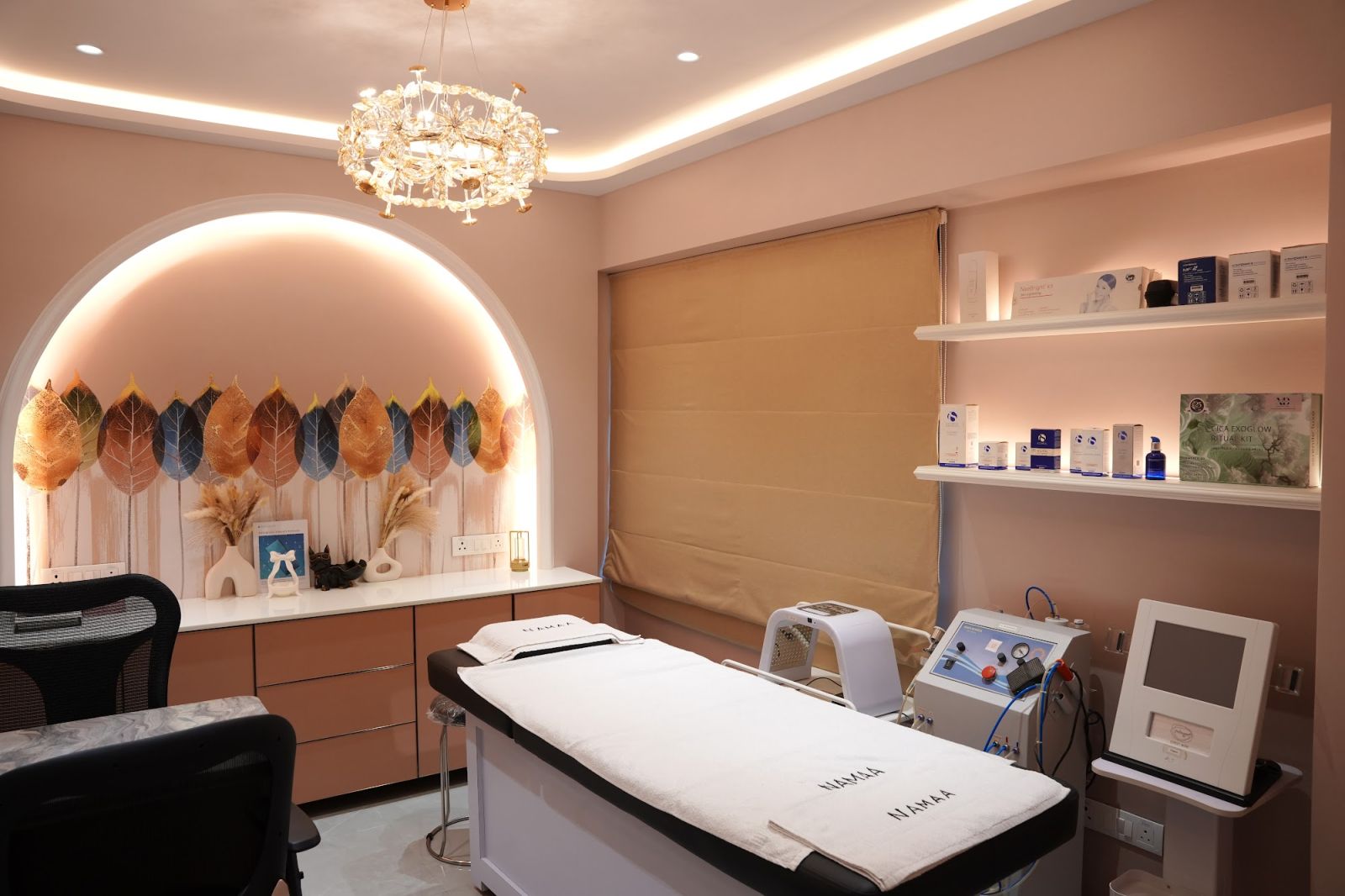 Blush-pink treatment suite with a lit arch and treatment devices